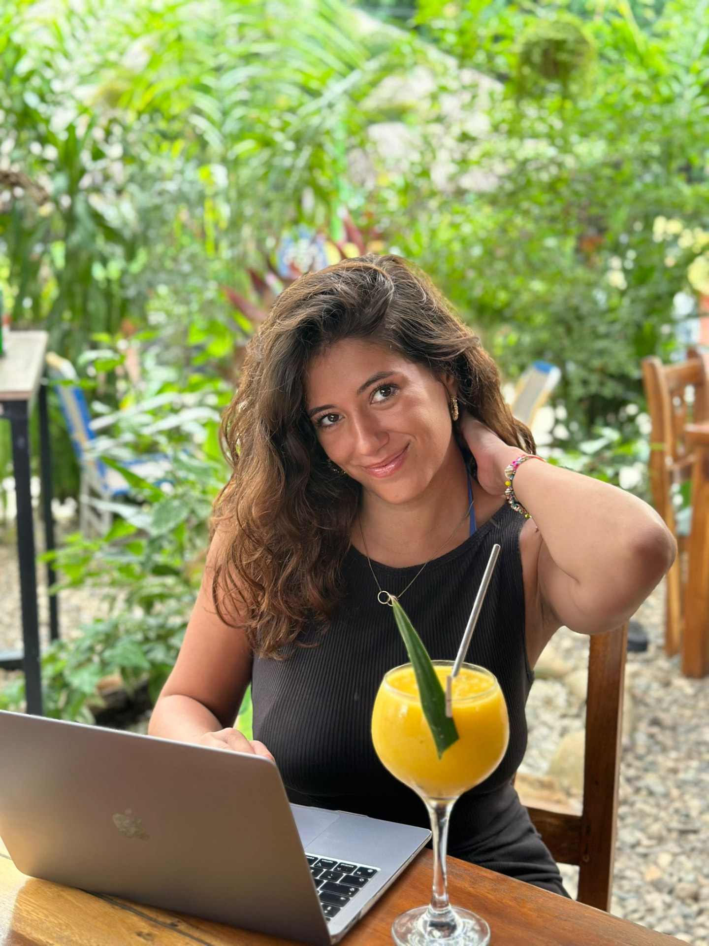 Ella working as a virtual assistant from a laptop abroad
